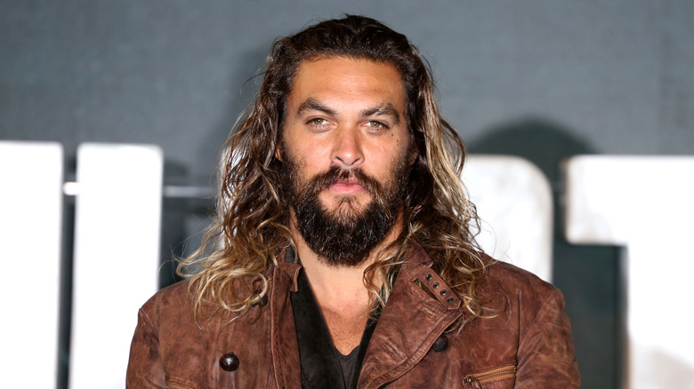 Jason Momoa wearing brown jacket