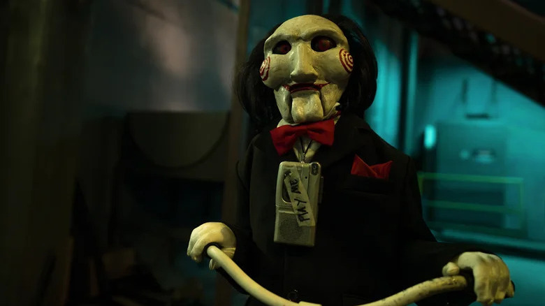 Billy the Puppet riding tricycle