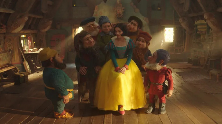 Snow White sitting with the dwarfs