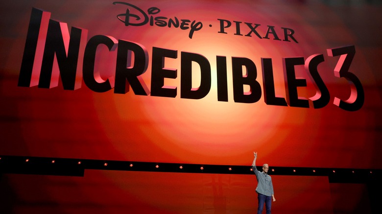 Pete Docter on stage at D23 in front of Incredibles 3 logo on big screen