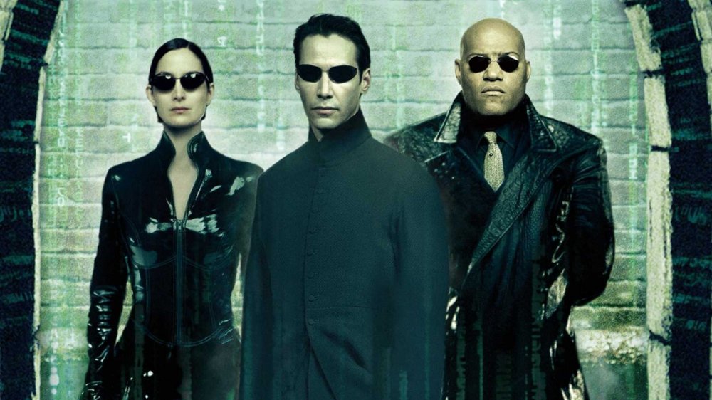 Keanu Reeves as Neo, Carrie-Anne Moss as Trinity, and Laurence Fishburne as Morpheus in The Matrix Reloaded