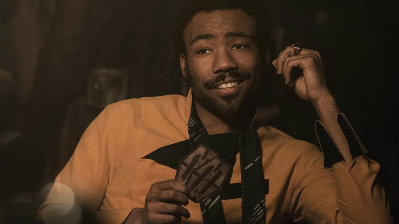 Lando playing cards and smiling