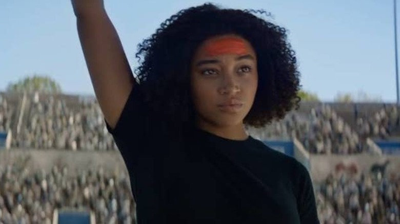 Rue raising their arm