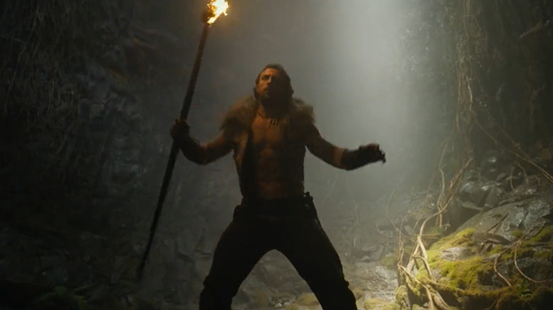 Kraven the Hunter holding torch in cave