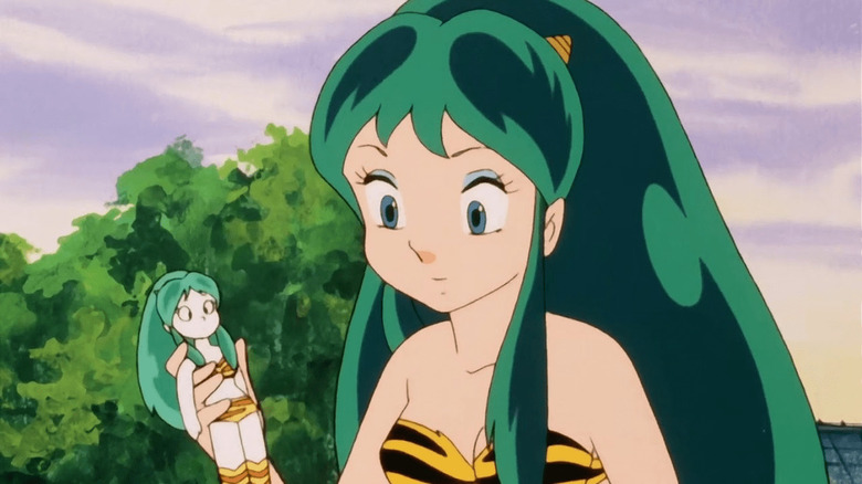 Lum holding doll of herself