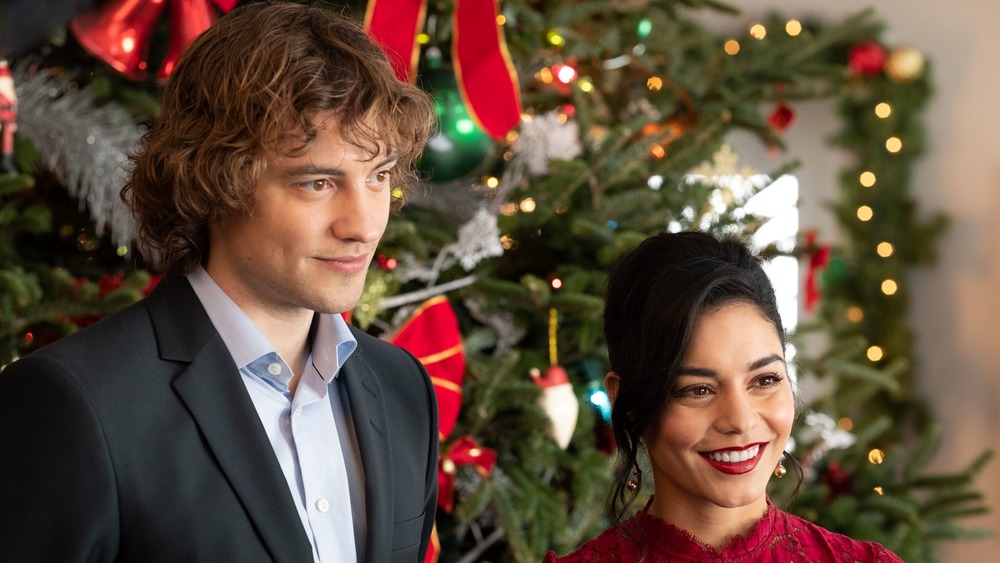 Cole (Josh Whitehouse) and Brooke (Vanessa Hudgens) attend a Christmas party in The Knight Before Christmas