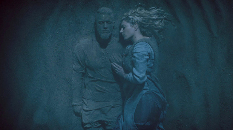 Lagertha lying next to Ragnar statue