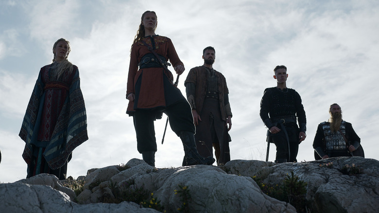 Gudrid, Freydis Eriksdotter, and Kolr stand on rock 