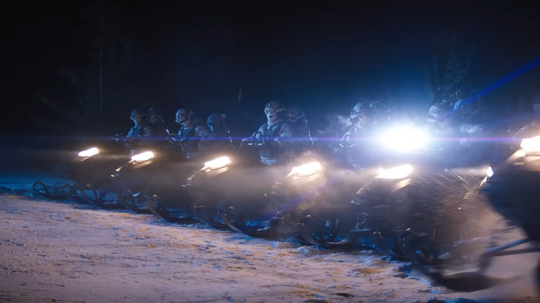 Soldiers ride snowmobiles