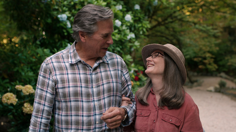 Doc and Hope smile with their arms linked