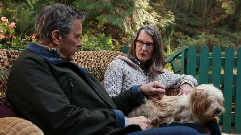 Hope and Doc sitting with dog on bench