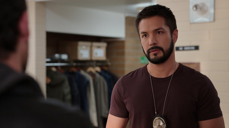 Mike wearing a dark red shirt and his police badge