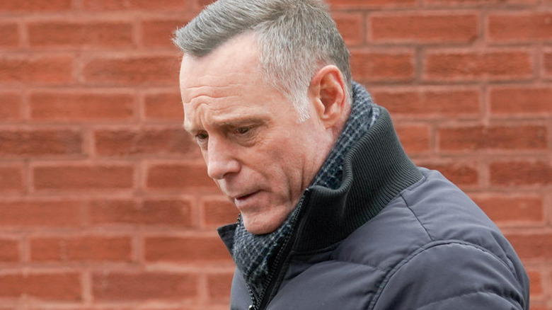 Hank Voight standing by brick wall