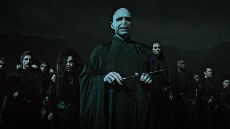 Voldemort standing with Death Eaters