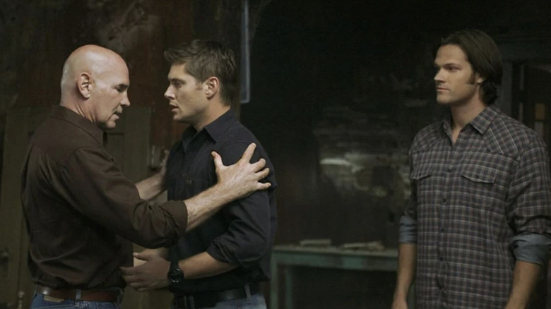 Samuel grabs Dean while Sam watches