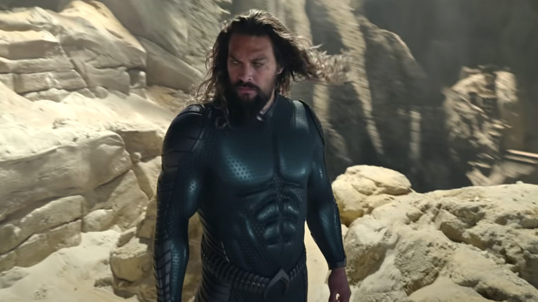 Aquaman stands on rocky cliff