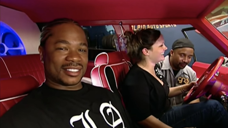 Xzibit in one of the pimped out cars, staring at the camera