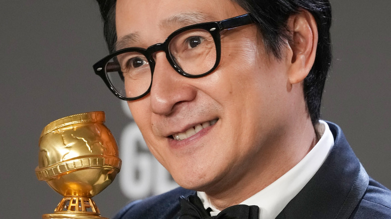 Ke Huy Quan smiles with golden globe