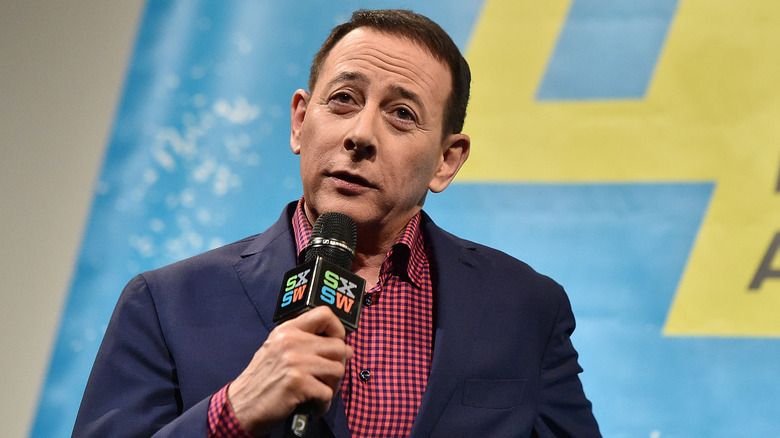 Paul Reubens holds a microphone at 2016 SXSW