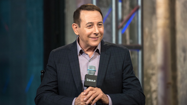 Paul Reubens sitting onstage at the AOL Build Speaker Series (2016)