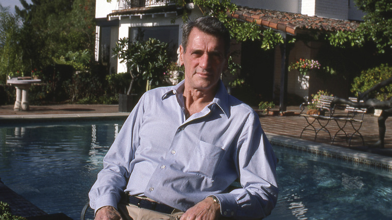 Rock Hudson sits by his pool (1985)