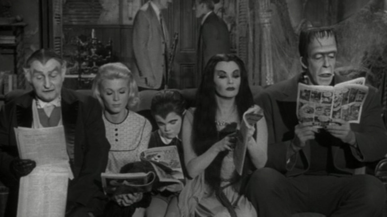 The Munsters reading newspapers