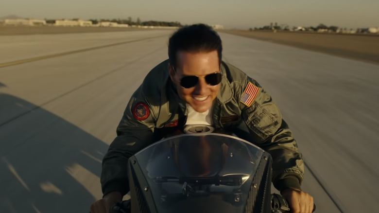 Maverick smiles while riding a motorcycle