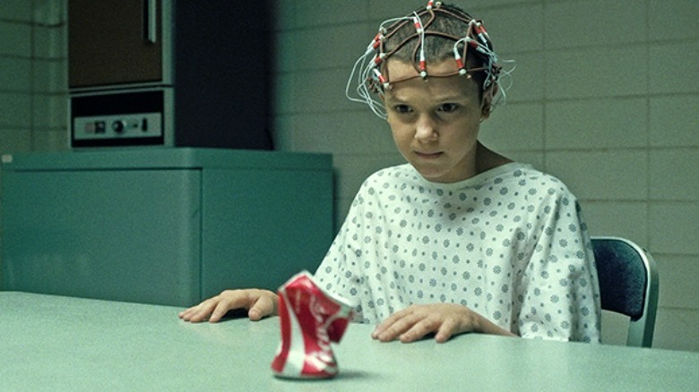 Eleven crushing a can with her mind