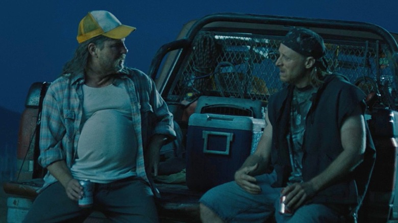 Two rednecks talking on truck