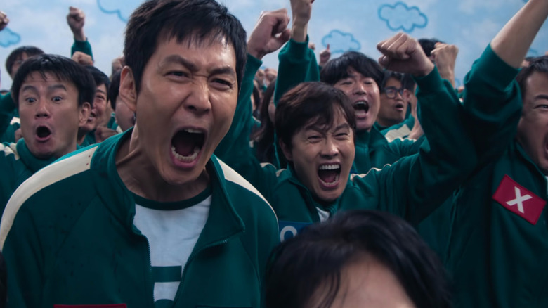 Gi-hun screams in victory at the pentathlon in "Squid Game" Season 2 (2024)