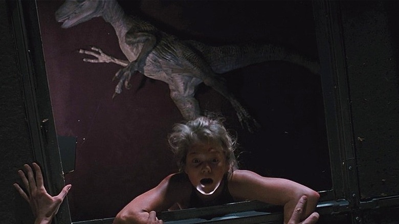 Lexi hanging from broken vent above raptor (1993)