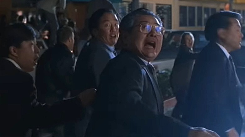 Japanese businessmen running away from T-Rex (1997)