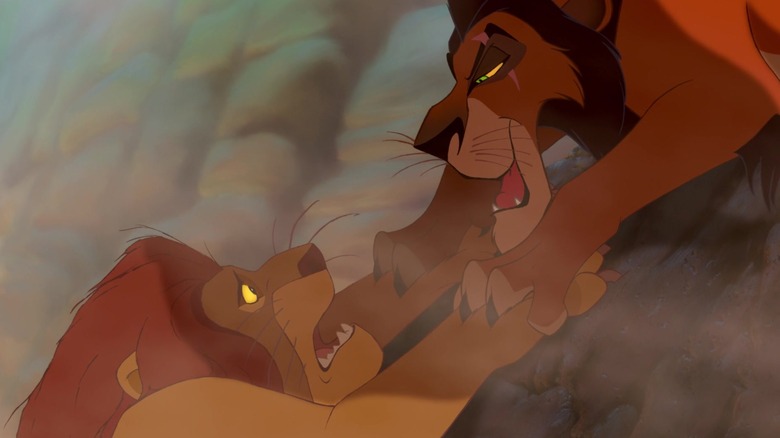 Scar looks down on Mufasa who is hanging on a cliff