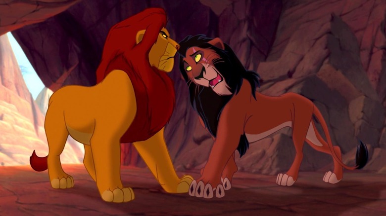 Mufasa and Scar stand across from each other in a cave