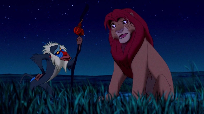 Rafiki and adult Simba look at each other under the stars