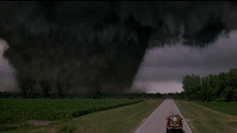 Car drives toward tornado