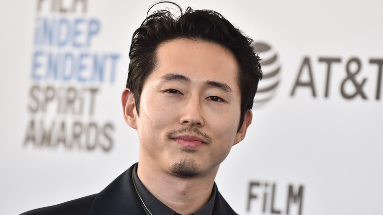 Steven Yeun smiling at event