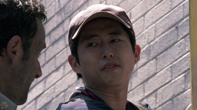 Glenn Rhee wearing red hat