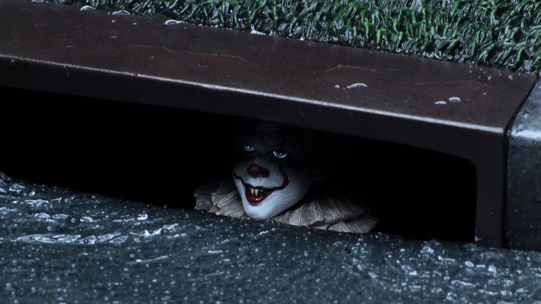 Pennywise peers out from sewers