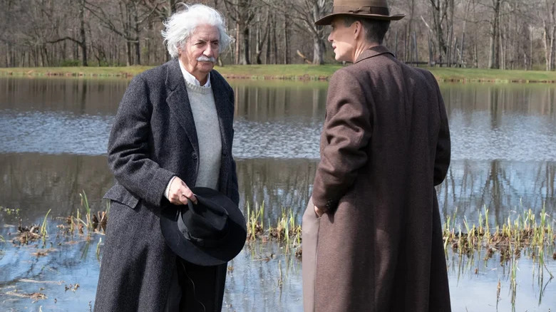 Einstein and Oppenheimer talk by a pond