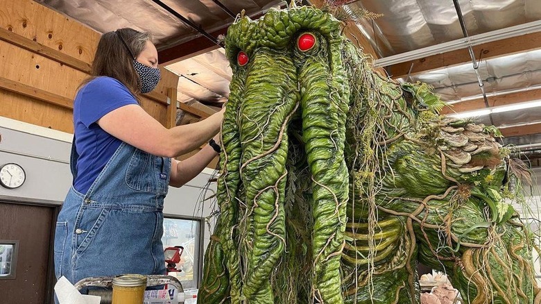 An artist working on the Man-Thing puppet