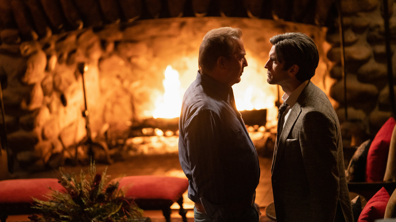 Kevin Costner as John Dutton and Wes Bentley as Jamie Dutton in front of fireplace in Yellowstone