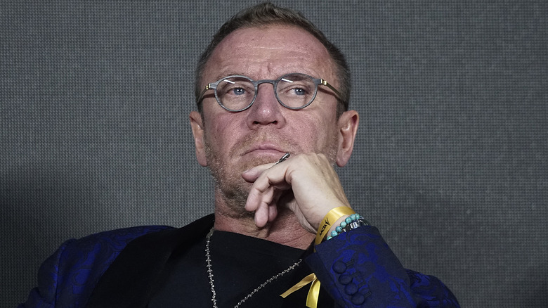 Renny Harlin hand to chin looking serious