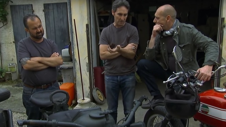 Mike Wolfe and Frank Fritz looking at a motorcycle