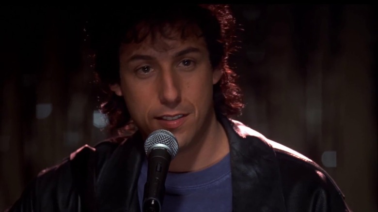 Robbie at a mic in The Wedding Singer