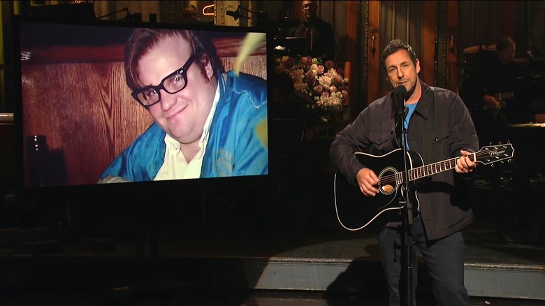 Sandler playing guitar next to a picture of Farley