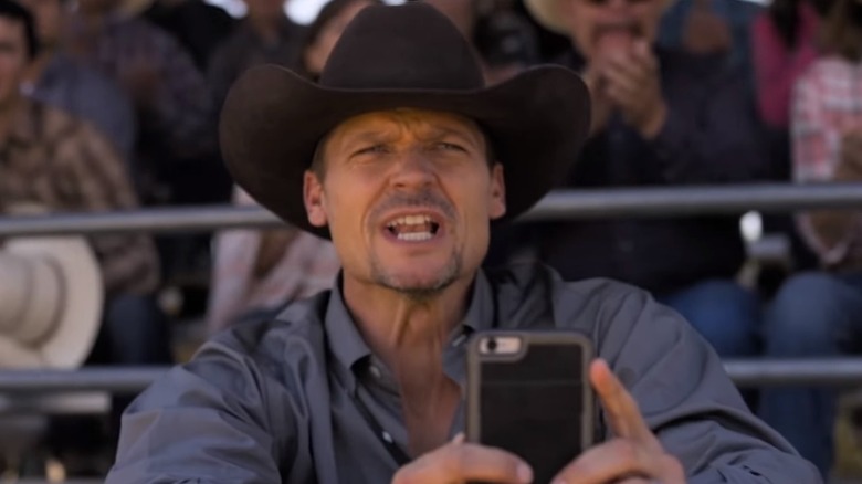 Cory Snyder at rodeo with phone