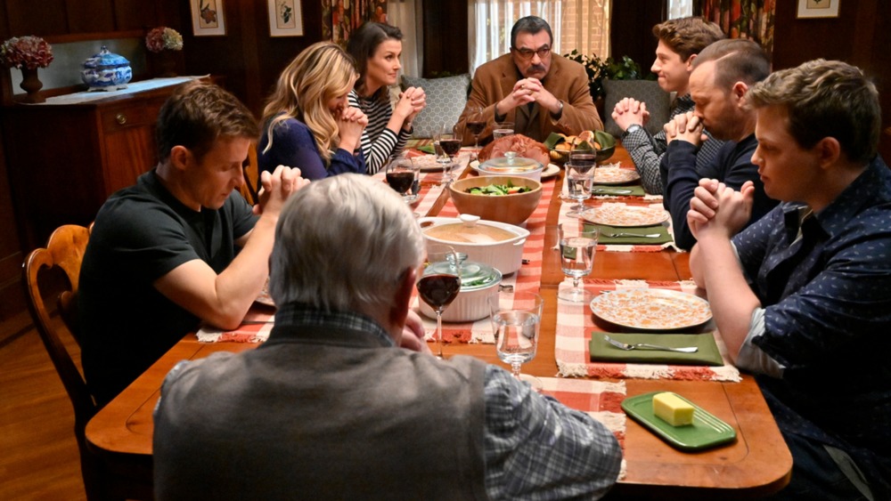 Frank Reagan (Tom Selleck) leads his family in prayer on Blue Bloods