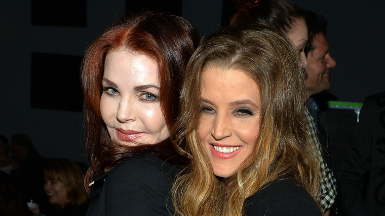 Lisa Marie and Priscilla Presley smiling for cameras