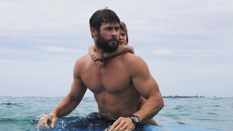 Chris Hemsworth surfs with his son